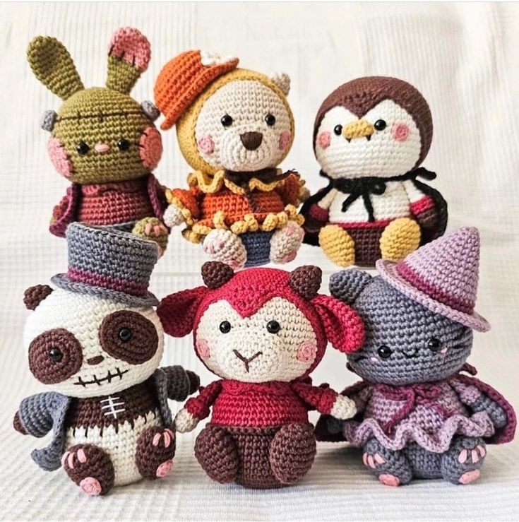 several crocheted stuffed animals are posed together