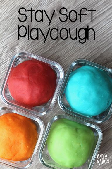 four different colored play doughs in plastic containers on a table with text overlay