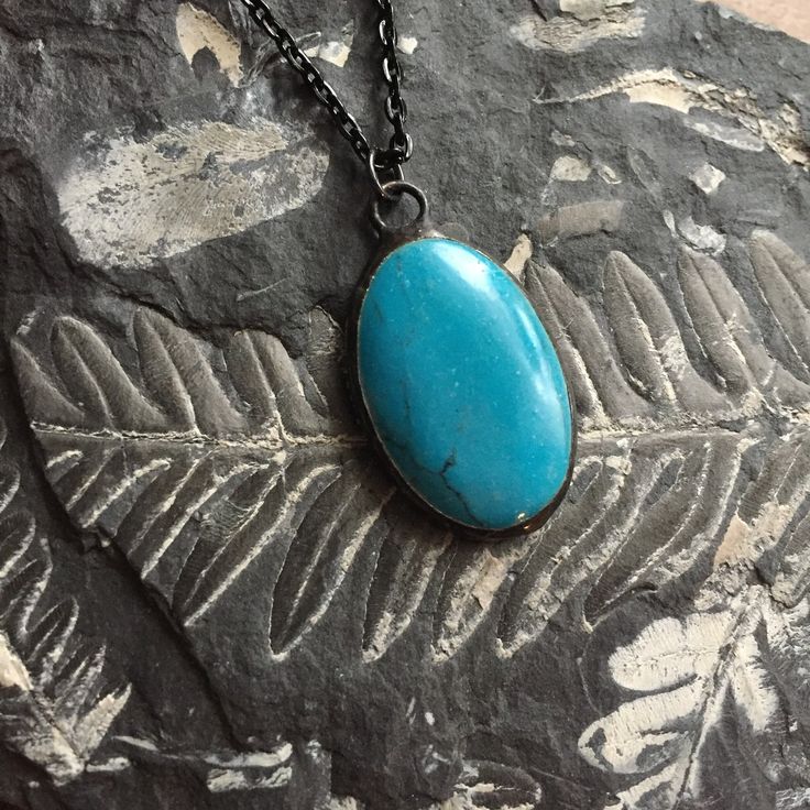 "Medium Oval Turquoise Howlite pendant necklace. Howlite: memory, creativity, patience. Artisan made hand-soldered with vintage finish.  Measures approx. 3/4\" x 1 1/4\" Chain has black finish and measures 24\" and has a lobster claw style clasp.   Cabochon is domed on the front and flat on the back. Reverse side shows the back of the stone.   All of my jewelry is made by me, expertly handcrafted and of heirloom quality.  I am the author of the bestselling jewelry books, Boho Chic Jewelry and Soldered Alchemy, and have been a jewelry artist for many years, so I have amassed quite a collection of unique stones. Please read the entire descriptions and view all photos before purchasing, as these sales are final. *Please note: props shown in photos are not included. This purchase is for the je Bohemian Oval Turquoise Necklace Gift, Bohemian Oval Turquoise Necklace As Gift, Oval Turquoise Spiritual Necklace Gift, Bohemian Turquoise Oval Pendant Necklace Gift, Bohemian Turquoise Necklace With Oval Pendant, Spiritual Oval Turquoise Necklace Gift, Handmade Turquoise Oval Pendant Necklace As Gift, Spiritual Turquoise Oval Pendant Necklace, Handmade Oval Turquoise Pendant Necklace As Gift