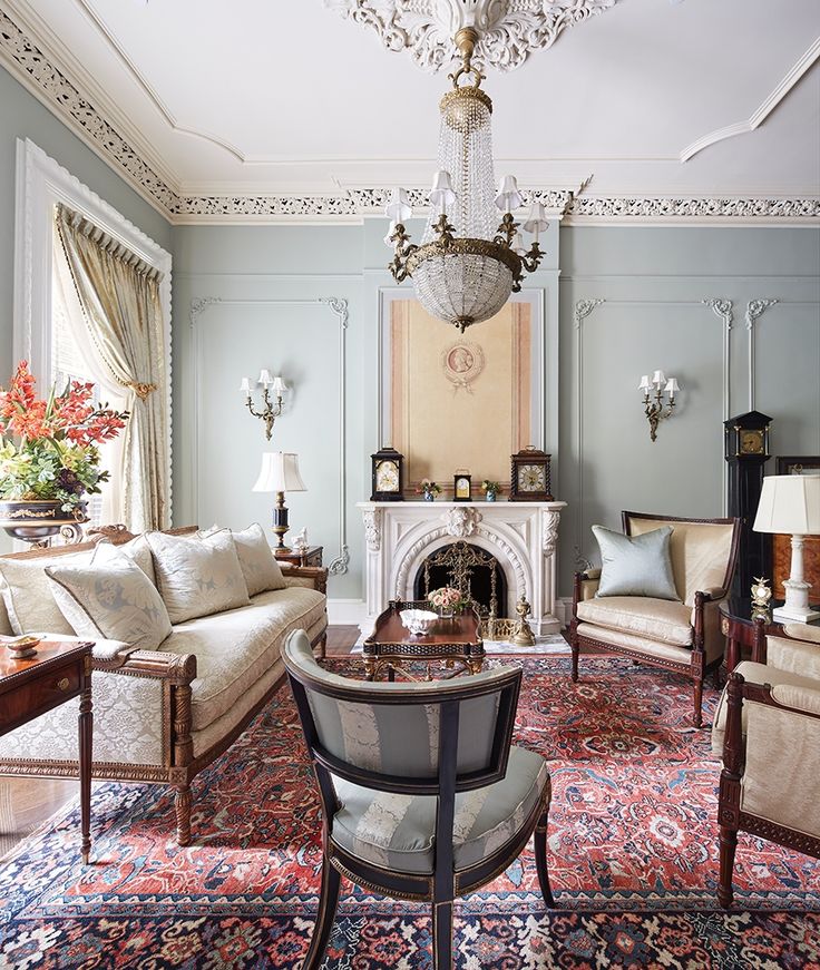 a living room filled with furniture and a fire place in the middle of a room