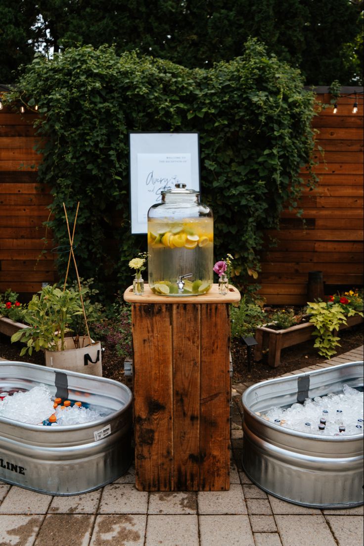 two metal buckets filled with liquid next to each other