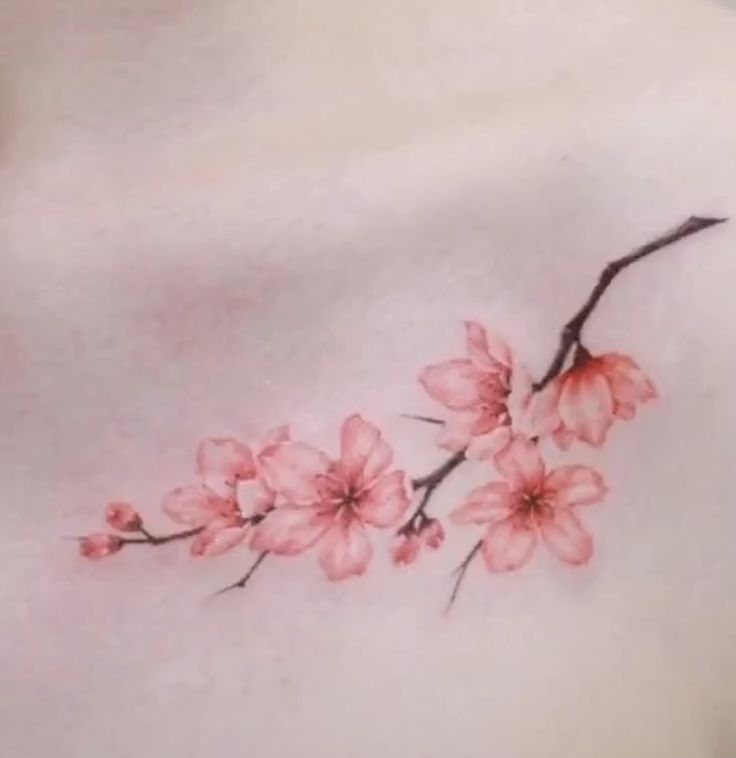 a woman's chest with pink flowers on it