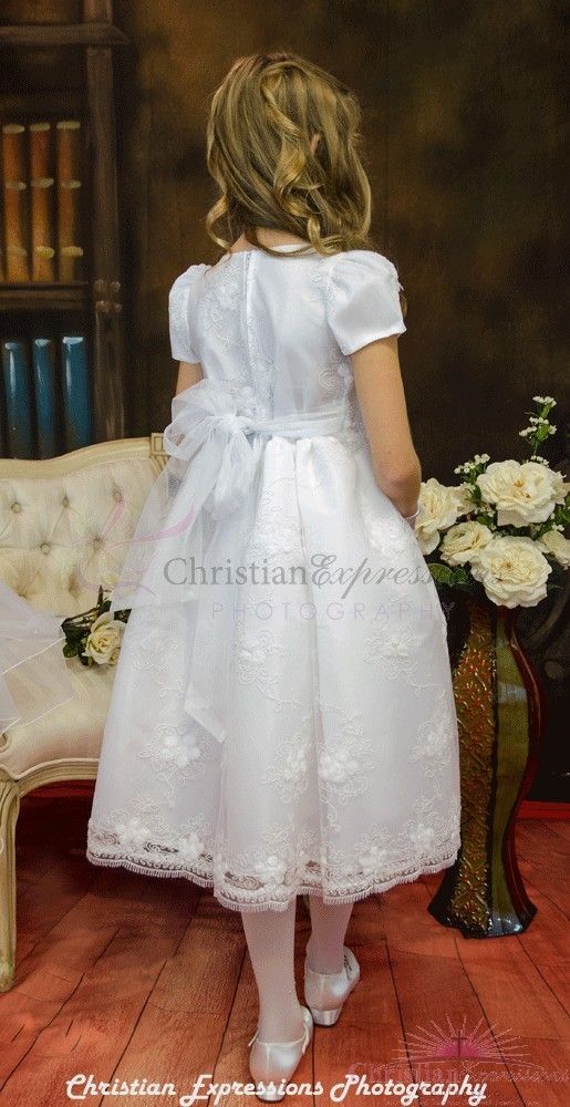 Short sleeve first communion dress made of satin and organza overlay with detailed floral embroidery. Beautiful scalloped hemline with floral accents. Zipper closure with bow  tie. The first communion dress is new for season 2016 and Made in the USA. This first communion dress is  Available in plus sizes White Communion Dress, First Holy Communion Dresses, First Communion Veils, Organza Overlay, Communion Veils, Holy Communion Dresses, First Communion Dress, First Communion Dresses, Communion Dresses