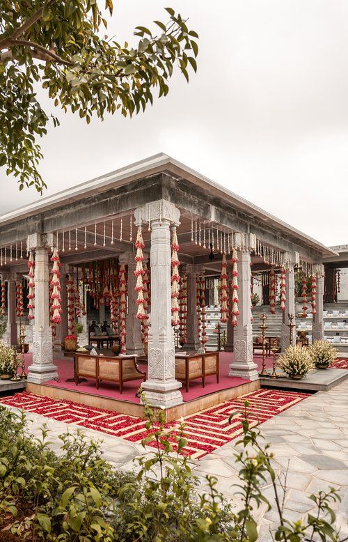 a building with red and white decorations on the front, and pillars in the middle