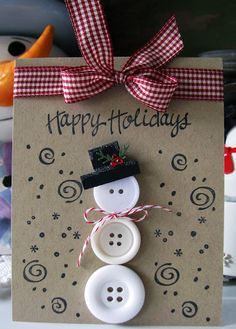 a happy holidays card with a snowman made out of buttons and a red ribbon