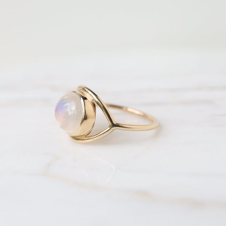 Moonstone cabochon 14k yellow gold 1.3mm band thickness Handmade by Halcyon Jewelry in Maine Timeless jewelry made by hand. Inspired by the ancients, imbued with magic, and made with love & sustainability in mind. Made with recycled metals and responsibly sourced stones. Yellow Gold Moonstone Jewelry With Birthstone, Minimalist Gold Moonstone Ring, 14k Gold Spiritual Moonstone Ring, Handmade Yellow Gold Moonstone Ring, Yellow Gold Open Ring With Moonstone, Handmade Dainty Yellow Gold Moonstone Ring, Handmade Yellow Gold Moonstone Ring Fine Jewelry, Handmade Fine Jewelry Yellow Gold Moonstone Ring, Heirloom Yellow Gold Moonstone Cabochon Ring