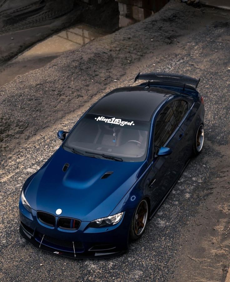 a blue car parked on the side of a road