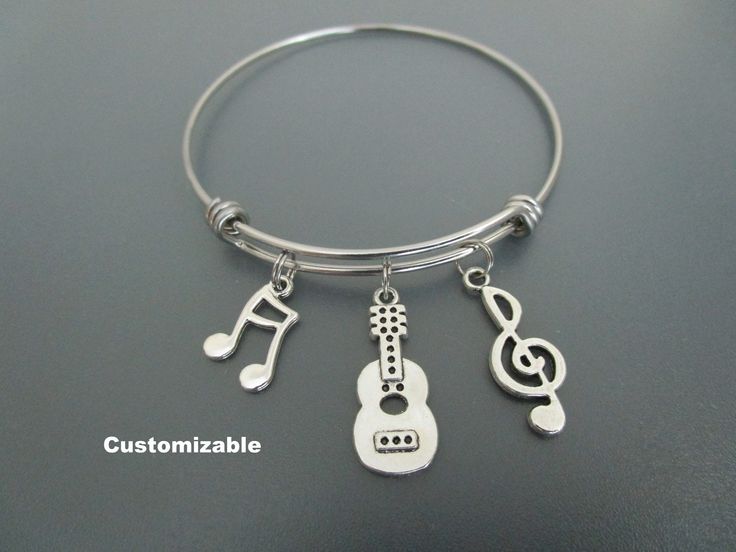 "Guitar Charm Bracelet / Music Note Bangle / Music Teacher Jewelry All my bracelets, bangles are customizable - please contact me if you want to add or exchange a charm, add a letter or number! A trendy, fun expandable and stackable charm bracelet! Perfect gift for those who love music and guitars! Made with treble clef, guitar and music note charms.  Your choice of - small/medium - adjust from just under 2.1/2\" (60mm) to 3\" (75mm) in diameter - medium/large - adjust from 2.3/4\" (65mm) to 3.3/8\" (80mm) in diameter Contract the wire coils to get a smaller fit and expand the coils for a larger fit. Add an initial charm  https://www.etsy.com/ca/listing/454708888/add-on-charm-add-a-personalized-initial?ref=shop_home_active_1 For personalized bracelet you can add a birthstone charm - please Adjustable Bracelet Jewelry For Concerts, Adjustable Metal Bracelets For Concerts, Silver Band Bracelets For Concerts, Adjustable Silver Bracelets For Concerts, Adjustable Music-themed Jewelry For Concerts, Nickel-free Music-themed Jewelry For Concerts, Adjustable Metal Music-themed Jewelry, Silver Bracelet For Concerts, Silver Bracelet Jewelry For Concert