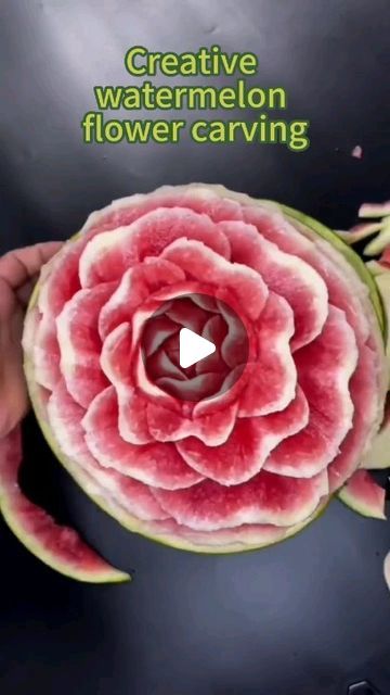 a watermelon flower carving being held by someone's hand with the words creative watermelon flower carving on it