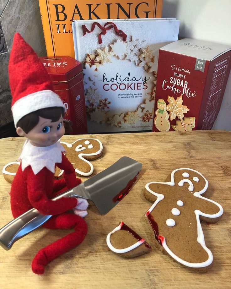 an elf is sitting next to some cookies