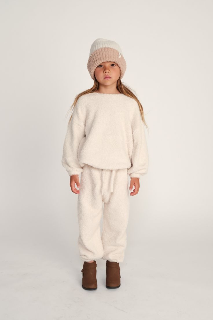 Cuddle up in these irresistibly cozy Boxy Lounge Pants! Made from 100% recycled materials, they're as comfy as can be, with a fuzzy feel that's perfect for the everyday. Unisex and cute, it's the perfect companion for little explorers.

Make it a set with the matching Boxy Sweater or mix and match with your favorite fuzzy tops. Wear at home and in your 7AM footmuff for the ultimate fuzzy experience. Cozy Sweatpants For Loungewear, Cozy Fit Sweatpants For Loungewear, Comfy Winter Bottoms For Relaxation, Comfy Bottoms For Winter Relaxation, Cozy Winter Loungewear Sweatpants, Cozy Sweatpants With Elastic Cuffs For Loungewear, Comfortable Cozy Sweatpants With Elastic Cuffs, Cozy Fit Sweatpants With Elastic Cuffs, Cozy Winter Pants With Ribbed Cuffs