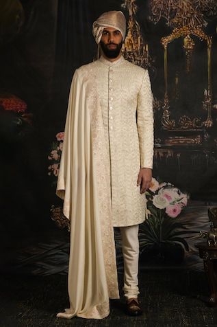 Regal rose sherwani with floral, intricate thread, tilla embroidery with dabka and sequins hand-embroidered collar. Comes with satin silk cream dupatta with four-sided floral border. Paired with kurta and churidar. - Aza Fashions Luxury Pink Sherwani With Dupatta, Wedding Silk Sherwani For Eid, Silk Sherwani With Zari Work For Wedding, Semi-stitched Silk Sherwani With Resham Embroidery, Eid Silk Sherwani With Dupatta, Designer Silk Sherwani With Traditional Drape, Silk Sherwani With Embroidery For Reception, Wedding Semi-stitched Silk Sherwani, Silk Sherwani With Zari Work And Traditional Drape