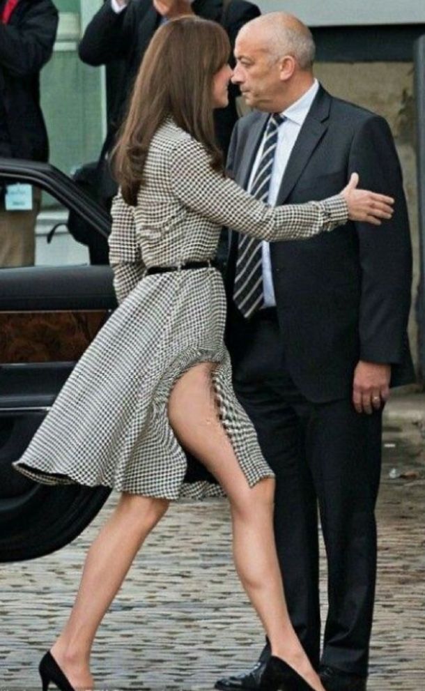 a man and woman in business attire standing next to each other with their hands together