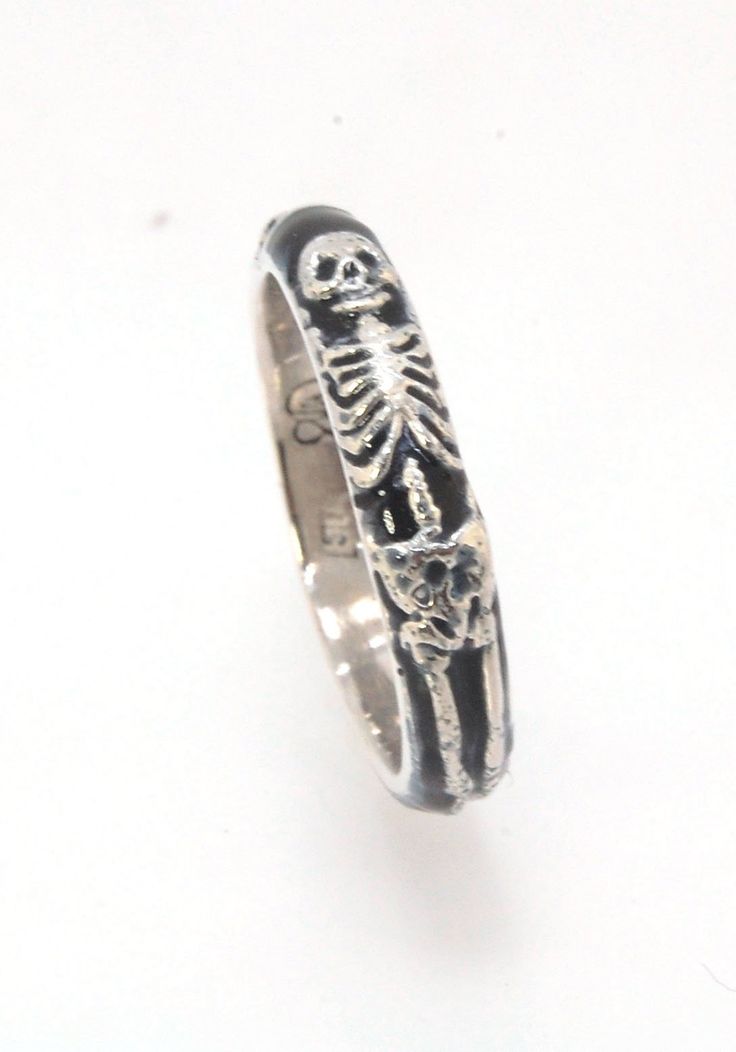 This is the middle width of my Memento Mori skeleton rings at 4mm wide. The Skeleton is flanked by crossed bones on one side and an hourglass on the other. Each ring in this collection is carved in wax by hand and cast using the ancient lost wax process. I then make a mold from which I can pull a wax copy of the original that can be resized to fit you and cast in silver or gold. These Skeleton rings are enameled with black glass in the recesses and polished to a high shine inside and brushed fin Skeleton Rings, Memento Mori Ring, Skeleton Jewelry, Skeleton Ring, The Skeleton, Rings Rings, Line Shopping, Hard Surface, Lost Wax