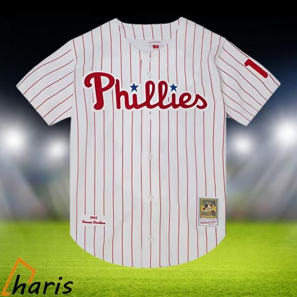 a baseball jersey with the word phillies on it in front of an empty field at night