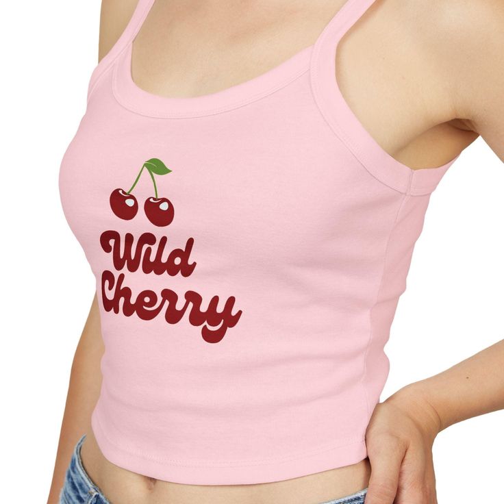 Add a pop of fun to your wardrobe with our fitted Wild Cherry Tank Top! This adorable top features a playful design with two cute cherries, making it a perfect addition to your wardrobe. This micro rib tank top features thick spaghetti straps and rests just above the belly button. It pairs effortlessly with your favorite jeans, shorts, or skirts. Available colors: ~Baby Blue ~Pink ~White Please see the detailed size chart to help you choose the right size. Fabric blend features 52% Airlume combed ringspun cotton and 48% Polyester for a soft and luxurious feel. Trendy Graphic Print Tank Top, Fitted Fruit Print Summer Tops, Casual Fitted Strawberry Print Tops, Retro Red Tops With Slogan, Fitted Casual Tops With Strawberry Print, Red Retro Slogan Tops, Fitted Cotton Tank Top With Slogan, Fitted Cherry Print Tops For Spring, Fitted Casual Tops With Cherry Print