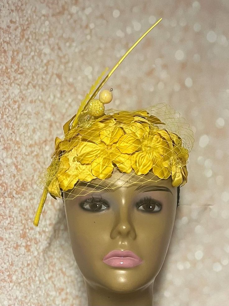 Yellow Flower Fascinator Half Hat, Church Head Covering, Headwear, Tea Parties, Weddings, and other Special Occasions Available in 2 sices:  10X7 inches 8.5X5.5 inches  The mannequin is wearing the 10X7. Golden yellow satin flowers, studs, feather stem and hat pin trims this gorgeous piece. The hat pin may vary and is for decorative purposes only and not to be used to hold hat to the head. The hat is affixed to the head via a hat string. Handmade gifts for women: wife, mother, sister, daughter or girlfriend. SHIPPING All items for free shipping will be shipped via USPS FIRST CLASS MAIL. Yellow Headband For Spring Party, Yellow Hair Accessories For Summer Party, Summer Ceremony Hats And Headpieces, Yellow Headband For Summer Wedding, Spring Wedding Headband Hair Accessories, Adjustable Summer Ceremony Headpieces, Spring Wedding Hair Accessories Headband, Yellow Summer Wedding Headband, Spring Ceremony Headband Fascinator