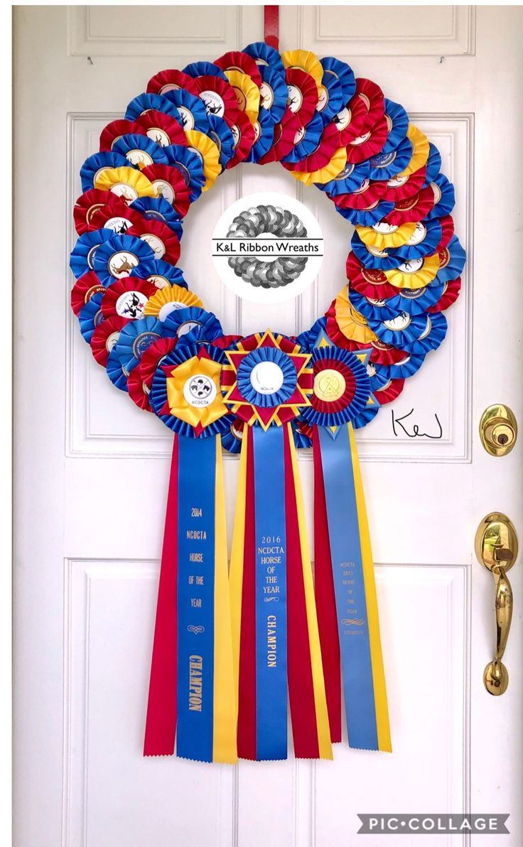 a wreath made out of ribbons hanging on a door with the words, welcome home