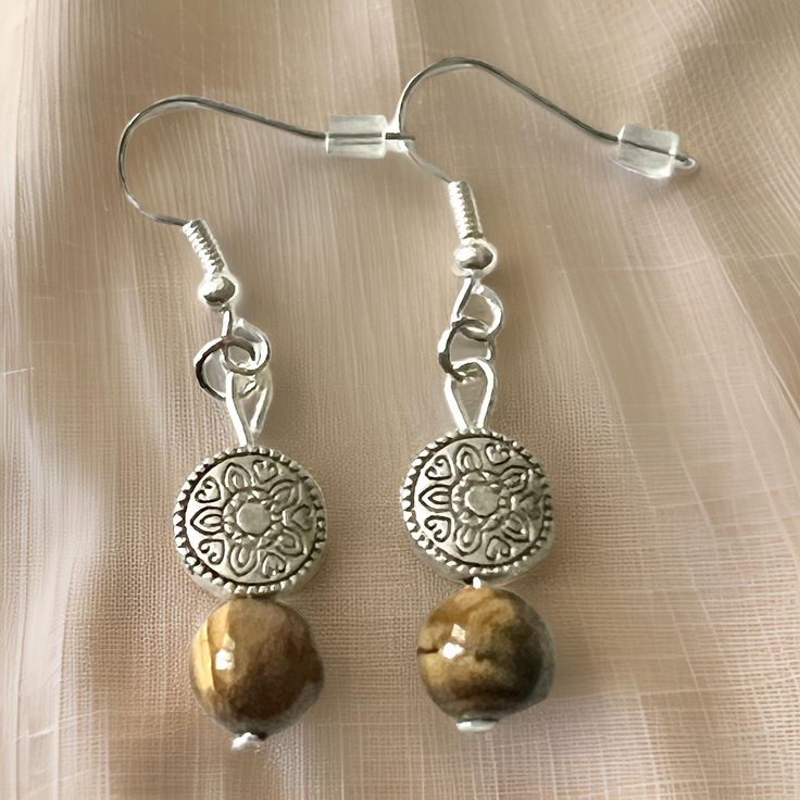 Women's | Girls,  Silver  boho hoop Earrings with Tiger Eye Stone  drops.    These simple designs are sure to capture an admirer and makes a fantastic gift. The tiger eye stone  creates the uniqueness in this set. approx length  1 1/2"Long Bohemian Brown Round Earrings, Brown Bohemian Round Earrings, Bohemian Brown Beaded Round Earrings, Nickel-free Brown Bohemian Earrings, Bohemian Nickel-free Round Beaded Earrings, Adjustable Earthy Dangle Earrings, Brown Bohemian Earrings With Round Beads, Bohemian Brown Earrings For Gift, Bohemian Brown Earrings As Gift