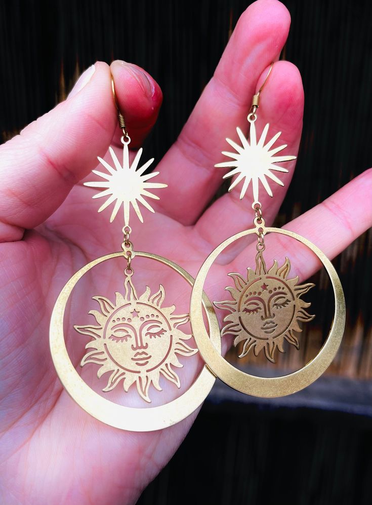 "Long, fashion, celestial, brass, drop/dangle, statement earrings: sun goddess and goddess of shooting stars; \"Novum,\" (aka Alectrona and Asteria). Total drop length: 3.5\" x 1.90.\"" Mystical Gold Earrings With Sun And Moon Design, Gold Sun And Moon Design Jewelry For Festivals, Celestial Jewelry For Festivals, Celestial Style Drop Earrings For Festivals, Celestial Style Pierced Jewelry For Festivals, Gold Sun And Moon Festival Jewelry, Gold Jewelry With Sun And Moon Design For Festivals, Brass Sun And Moon Design Earrings For Festival, Brass Sun And Moon Festival Earrings