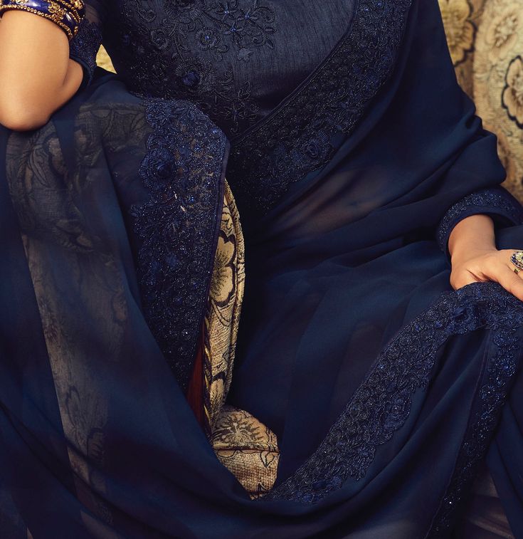 COLOR : Navy Blue FABRIC : Saree - Georgette, Blouse - Georgette & Net WORK : Resham Embroidery, Sequins, Stones, Motifs & Lace BorderOCCASION : Wedding, Sangeet, Party Wear, Festival READY-TO-WEAR : No STITCHING : Available as semi-stitched fabric, can be stitched using standard size option (+$20). Note: There might be a slight color variation due to lighting and flash used during photoshoot. The bright shade seen is the best closer view of fabric's color. Saree Georgette, Resham Embroidery, Party Wear Saree, Georgette Blouse, Navy Blue Fabric, Wear Saree, Party Wear Sarees, Blue Fabric, Fabric Color