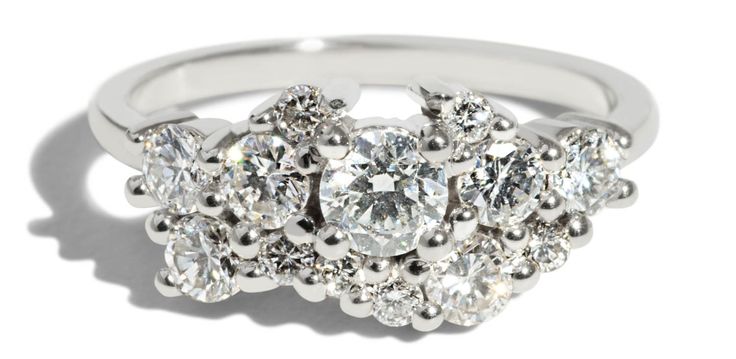 This Custom Heirloom Diamond Cluster Ring features a .25ct heirloom diamond, nine 2.8mm diamonds, and six 1.75mm diamond set in 14kt white gold with a polish finish. If you are interested in designing your own custom ring, fill out our Love Jewelry, Cluster Engagement Ring, Customized Jewelry, Gold Bracelets, I Love Jewelry, Diamond Cluster Ring, Diy Schmuck, Diamond Cluster, Gold Engagement Rings