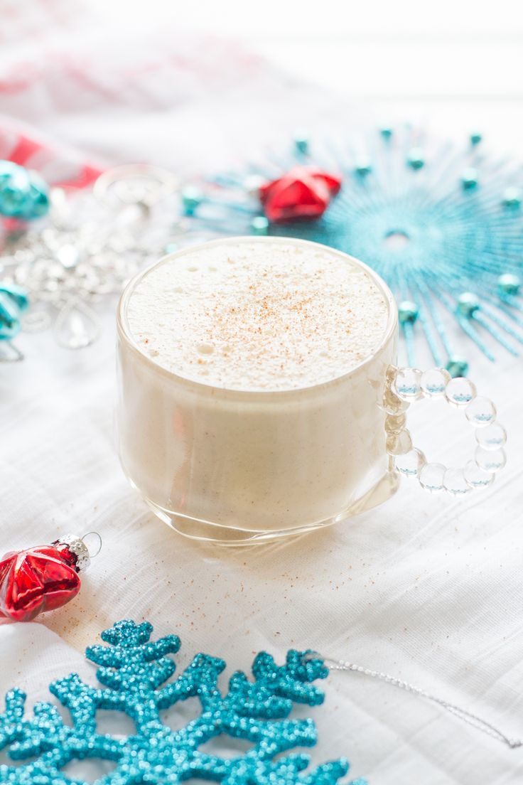 coconut milk eggnog recipe on a table with blue snowflakes and candy