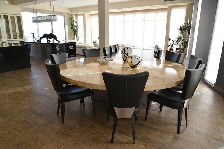 a dining room table with black chairs around it