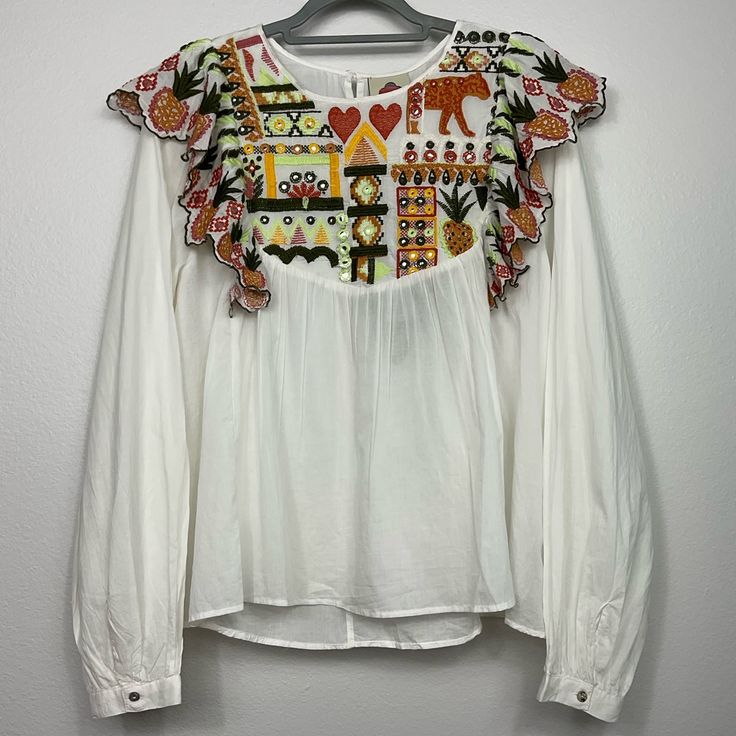 Nwt Off White Multicolor Embroidered Long Sleeve Top. Single Button Closure In Back Pleated Long Sleeves With Button Closure At Wrist Pineapple Embroidered Ruffle At Shoulders Embroidered Motif Lightweight 100% Cotton Crew Neck Measurements Are Flat Lay And Approximate. Bust 22in. Shoulders 15.5in. Length 25in. In Front, 26in. In Back Sleeves 27in. White Embellished Cotton Tops, Folk Style Embroidered White Top For Fall, Folk Style White Embroidered Top For Fall, White Blouse With Embroidered Sleeves For Fall, White Embellished Long Sleeve Blouse, White Long Sleeve Top With Embroidered Hem, White Embroidered Top For Fall, White Embroidered Cotton Top For Fall, White Embellished Long Sleeve Tops