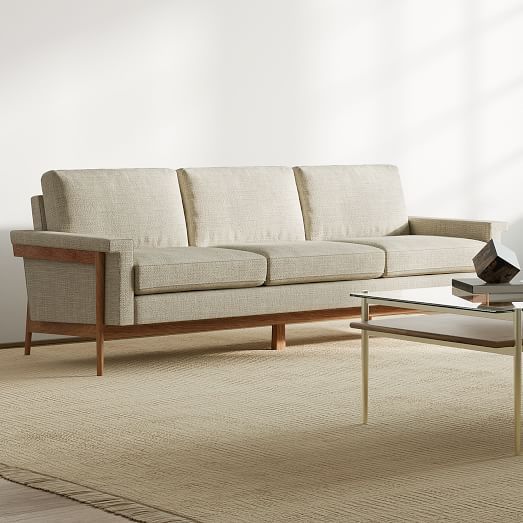 a living room scene with focus on the couch and coffee table in the foreground