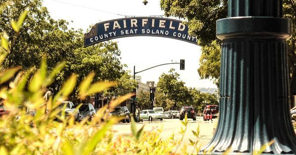 the street sign for fairfield county seat and solano county is in front of some trees