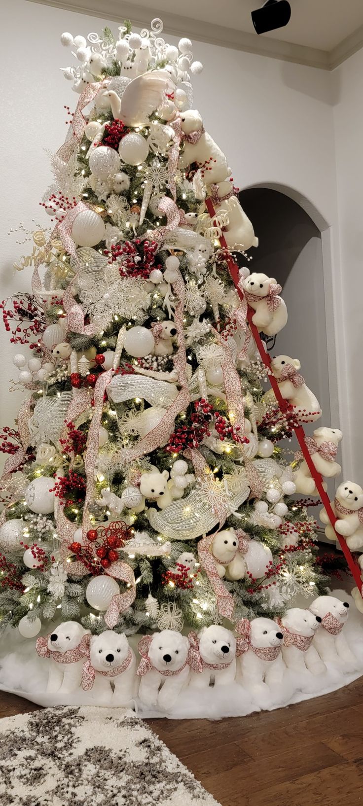 a decorated christmas tree with white and red ornaments