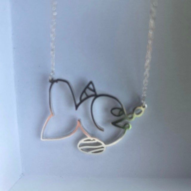 two necklaces that have been made to look like birds on a string with the words love