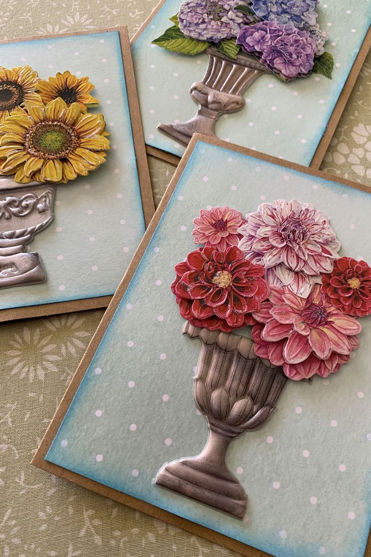 three cards with flowers in vases on them