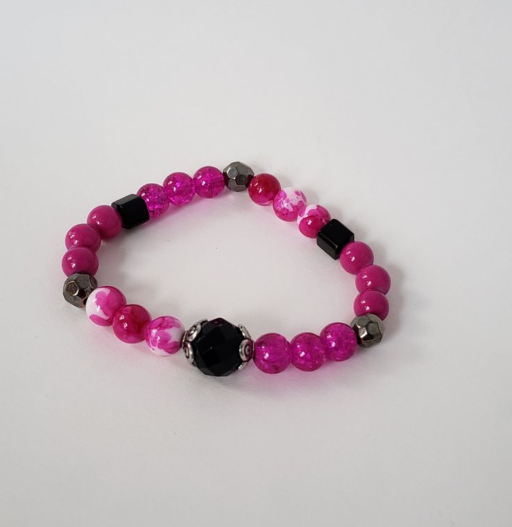 Add a little fun with this bright pink and black bracelet with elastic band. Handmade in the U.S. by Cogan Couture. Trendy Adjustable Black Beads Stretch Bracelet, Pink Flexible Beaded Bracelets For Gifts, Adjustable Purple Bracelets With Black Beads, Pink Beaded Bracelets For Gift, Adjustable Purple Bracelet With Black Beads, Pink Jewelry With Adjustable Black Beads, Adjustable Black Stretch Bracelet For Friendship, Pink Adjustable Stretch Bracelet As Gift, Pink Jewelry With Black Beads For Gift