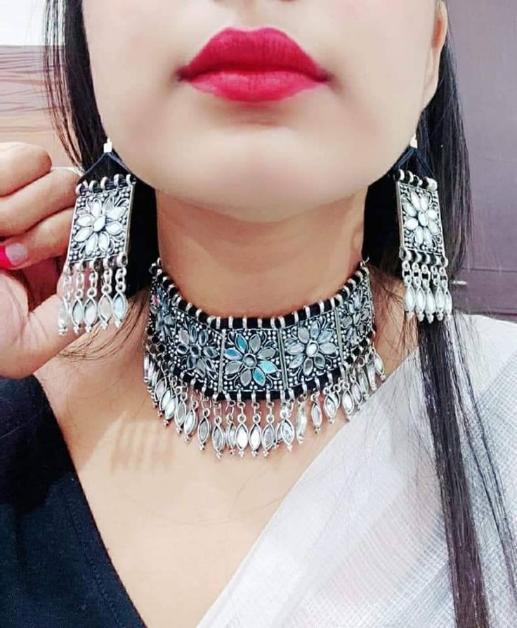 Add charm and charisma to your beautiful personality with this intricately designed and handcrafted Afghani glass work necklace in high quality German Silver.Earrings are also designed beautifully and compliment the choker very well. Wear it with any of your formal or casual outfits and grab compliments all the way! Drop length from top to bottom 6 inches approx with an adjustable black chord at the back Weight of the choker is 76 gm Earrings length 3 inches Each earring weighs 15 GM's Bohemian Chandbali Beaded Jewelry, Bohemian Beaded Chandbali Jewelry, Navratri Metal Dangle Jewelry, Silver Chandbali Necklace With Mirror Work, Bohemian Kundan Beaded Jewelry, Bohemian Kundan Necklaces, Metal Dangle Jewelry For Navratri, Silver Jewelry Sets With Mirror Work For Festivals, Bohemian Jewelry Sets With Intricate Design For Celebration