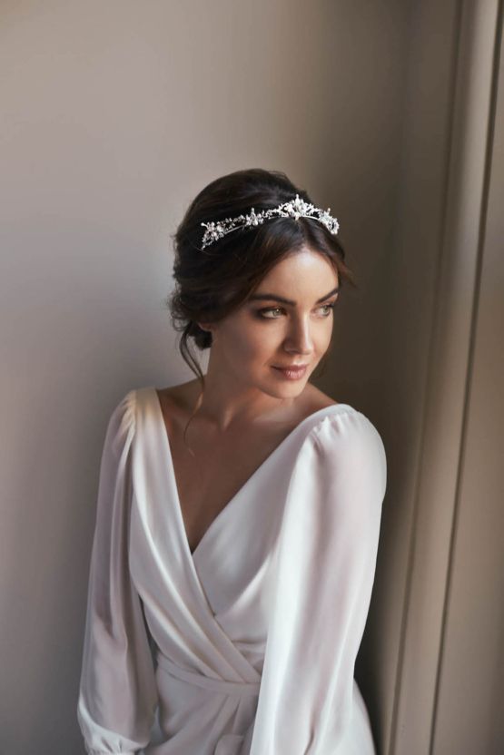 a woman in a white dress wearing a tiara