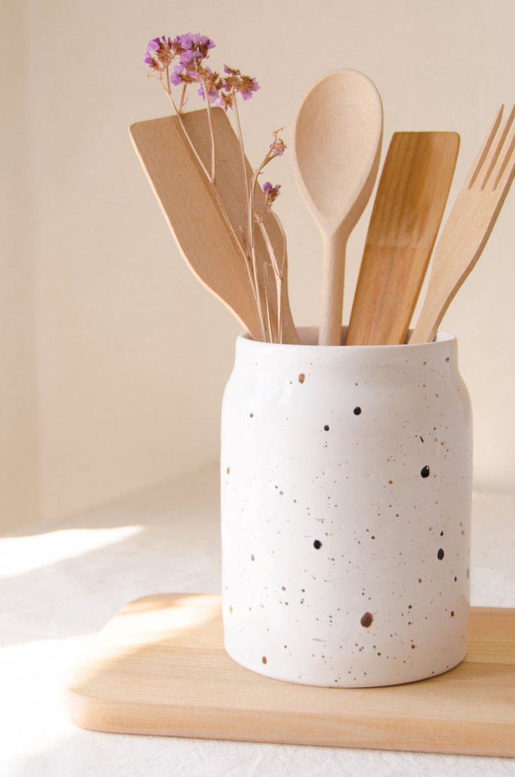 spoons and utensils in a white ceramic container