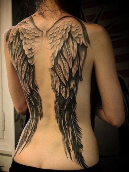 the back of a woman's body with wings on it