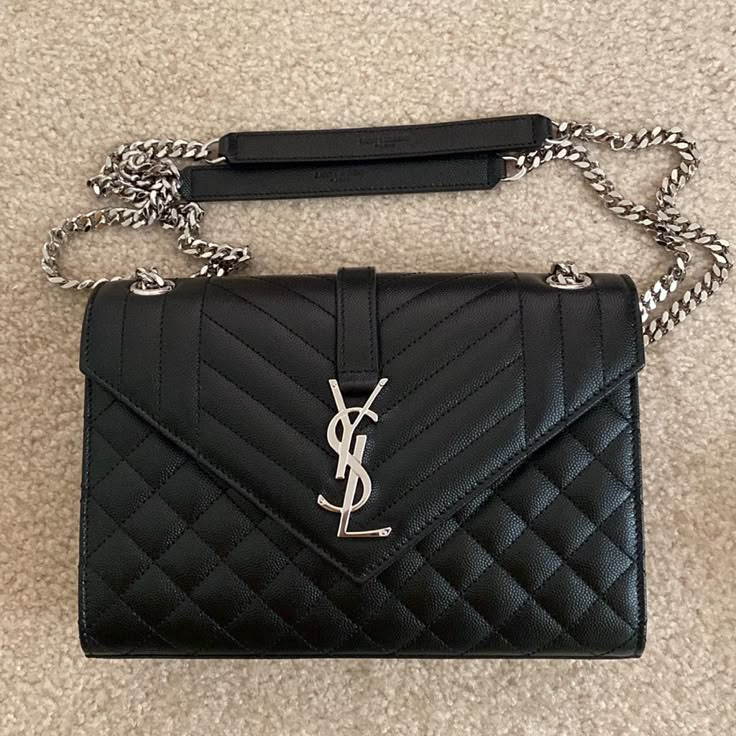 Like Brand New. Used Only 1-2x. No Damages/Scratches. Black With Silver Hardware. Sticker Protector On Clasp In Place. Dust Bag, Box, Card Included. Dimensions: 24 X 17,5 X 6 Cm / 9.4 X 6.8 X 2.3 Inches Ysl Bag Matte Black, Ysl Envelope Medium Bag, Girl Techwear, Dark Academia Grunge, Bags Ysl, Yves Saint Laurent Bags, Skater Girls, Envelope Bag, Box Card