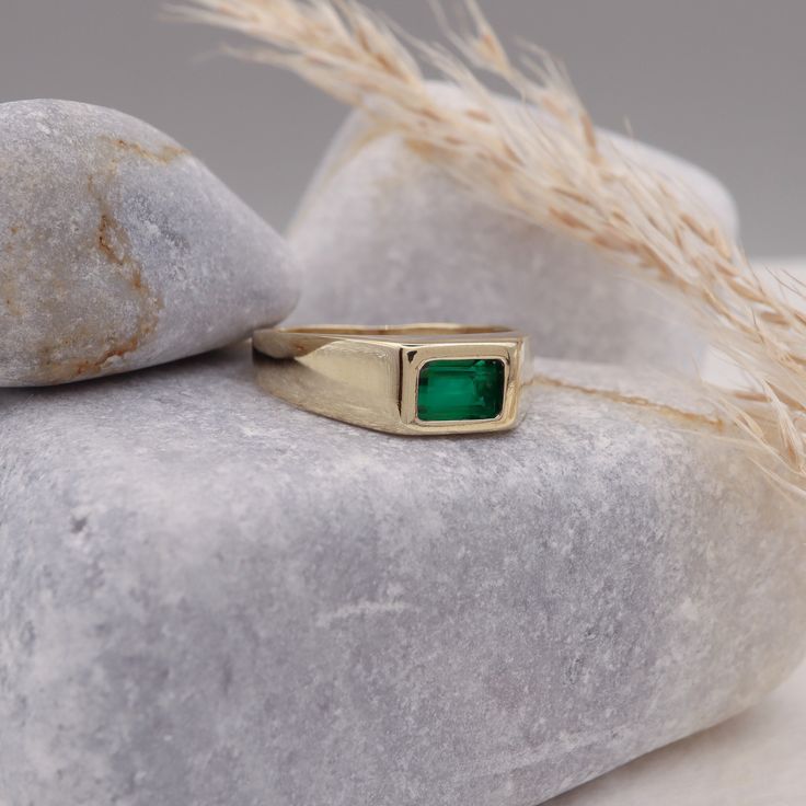 This 14k Natural Emerald Baguette Signet Ring is an exquisite piece of May birthstone jewelry. Crafted with precision, this ring showcases a vibrant green natural emerald stone, symbolizing youth and rejuvenation. Designed to suit both men and women, it serves as a versatile accessory, perfect for any occasion. The chunky yet elegant design adds a touch of sophistication, while the pinky ring style adds a trendy element. Whether it's an anniversary celebration or a special gift, this ring makes a truly timeless and meaningful statement. Elevate your jewelry collection with this mesmerizing emerald signet ring. Measurements: * Gem Stones: 100% Natural Emerald * Center Stone Measurements: 6.00x4.00 Approx. 0.50 * Color and Clarity: Clear Green * Material: High-Quality Solid Gold 14/18k ----- Emerald Stone Rings For Men, Emerald Signet Ring Men, Elegant Green Emerald Cut Signet Ring, Emerald Cut Baguette Diamonds May Birthstone Jewelry, Emerald Cut Baguette Diamond Jewelry For May Birthstone, Emerald Baguette Cut Ring With Bezel Setting, Bezel Set Baguette Cut Emerald Ring, Modern Emerald Cut May Birthstone Jewelry, Formal Emerald Ring With Rectangular Stone