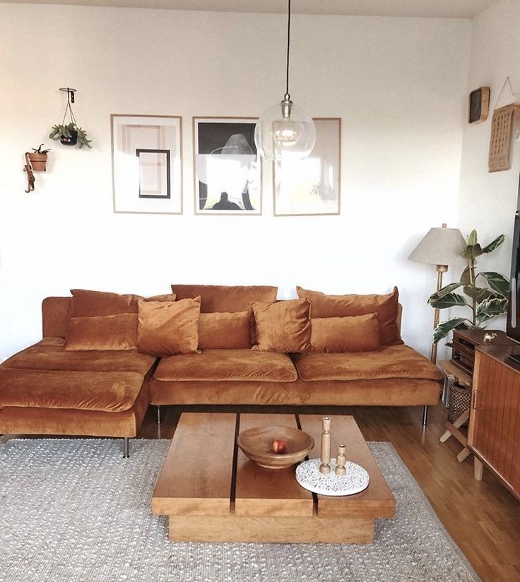 a living room with a couch, coffee table and television on top of the tv stand