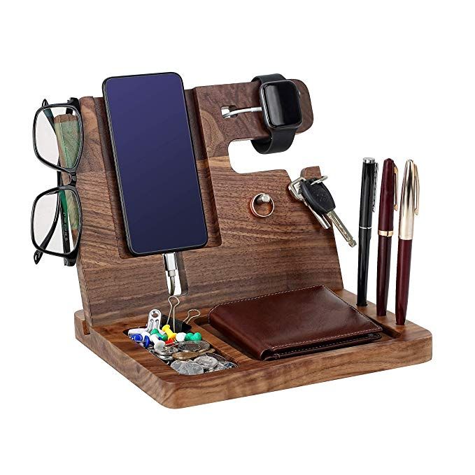 a wooden desk organizer with pen, glasses and cell phone in it's holder