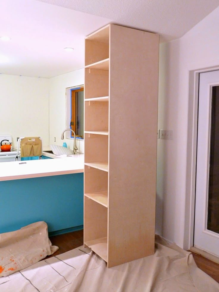 an unfinished kitchen with blue and white walls