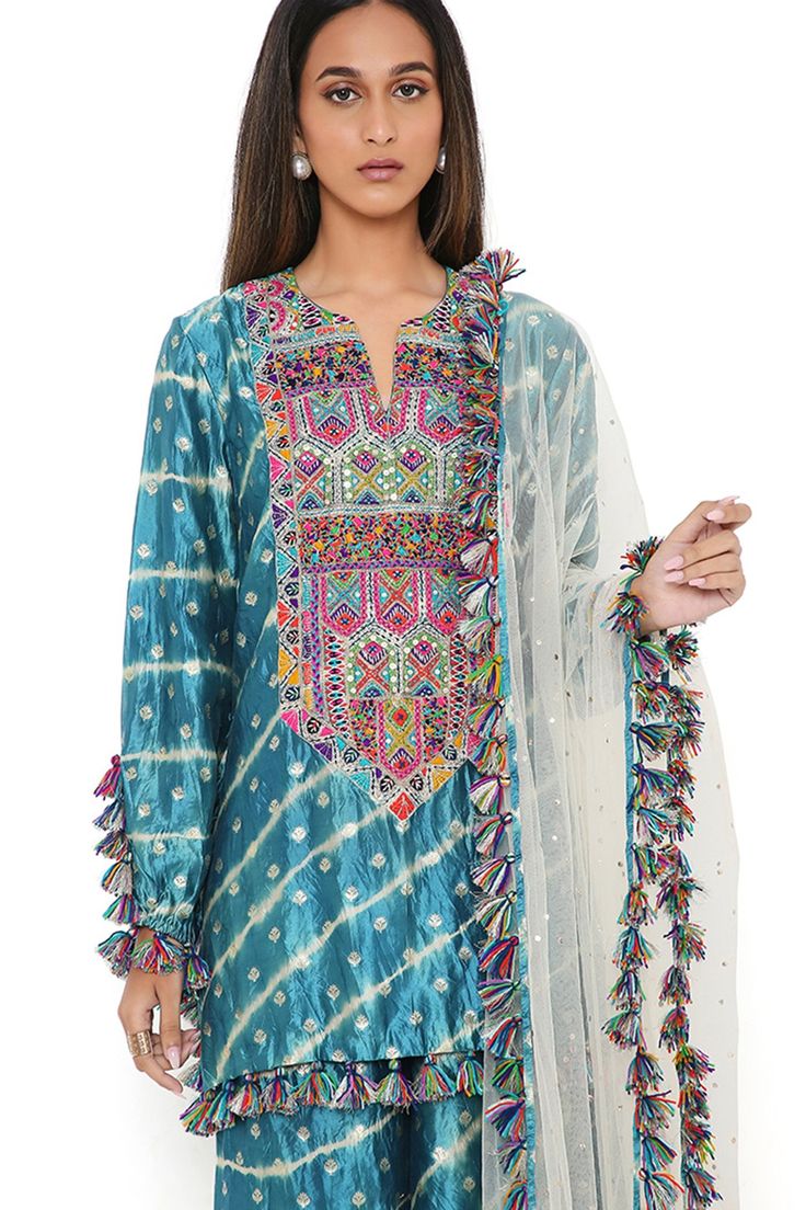 Aqua silk bandhani leheriya kurta with multi colored embroidered yoke. Comes with matching sharara and stone mukaish net dupatta.
Component: 3
Type Of Work: Bandhani, Leheriya Pattern
Neckline: Notched
Sleeve Type: Full
Fabric: Silk, Net
Color: Blue
Other Details: 
Fringed thread tassel details
Asymmetric hem
Frill hem sharara
Occasion: Wedding - Aza Fashions Kurta Sharara Set, Payal Singhal, Kurta Sharara, Types Of Work, Luxury Sale, Sharara Set, Net Dupatta, Fabric Silk, Blue Silk