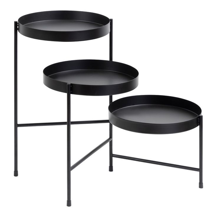 two black trays sitting next to each other on top of a table with metal legs