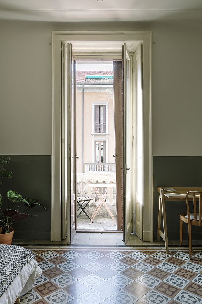 an open door leading into a bedroom with a bed and table in the room next to it