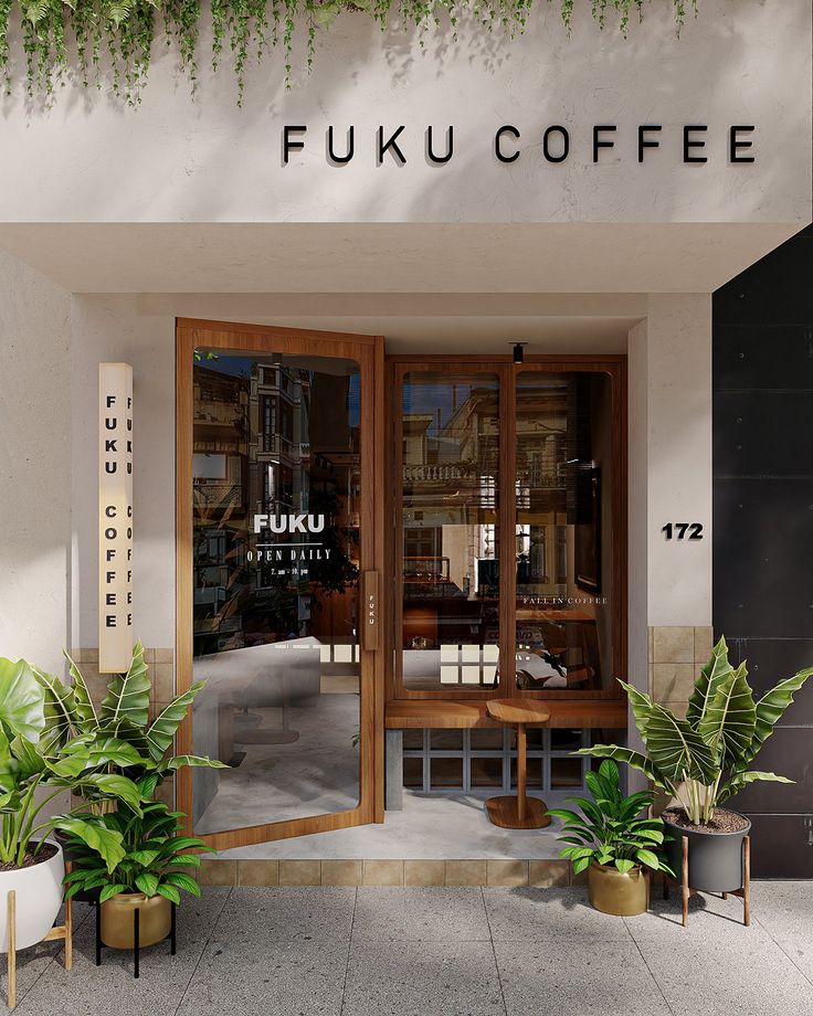 an entrance to a coffee shop with potted plants