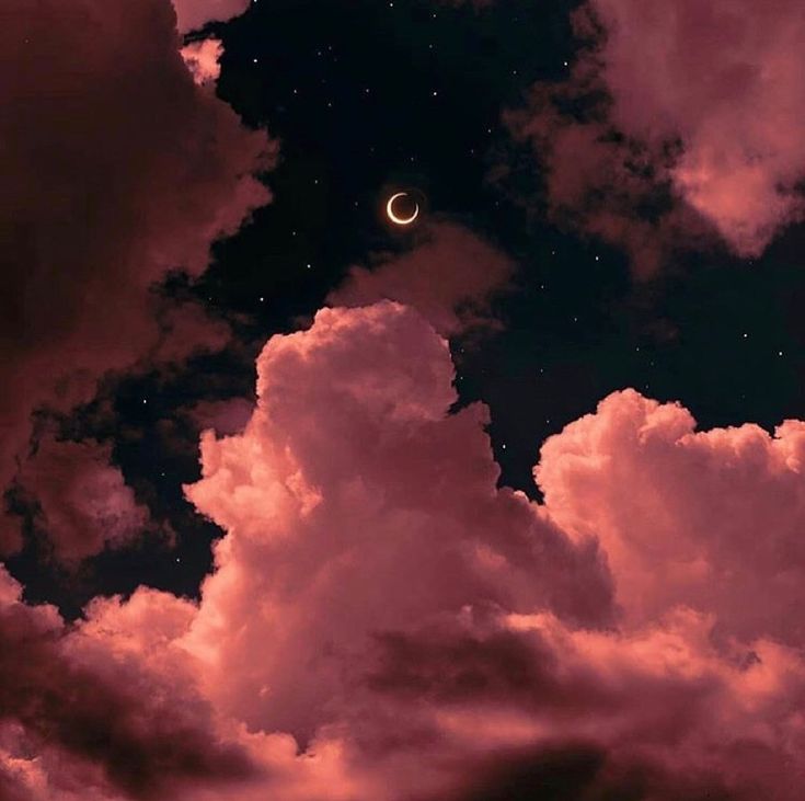 the moon is in the sky with clouds and stars around it, as well as some pink hues