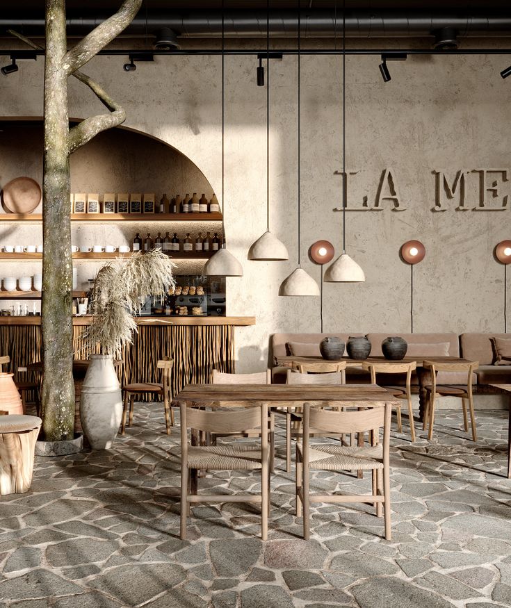 the interior of a restaurant with tables, chairs and potted plants in front of it